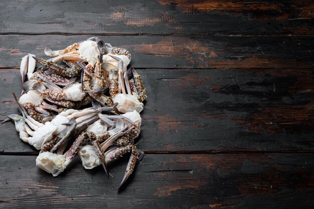 Fresh raw Horse crab, Blue crab, Flower crab set, on dark wooden background, top view flat lay , with copyspace  and space for text