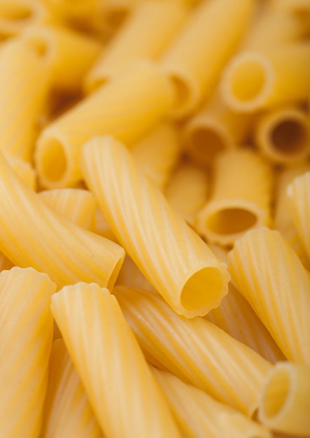 Fresh raw italian homemade penne pasta close up background Macro