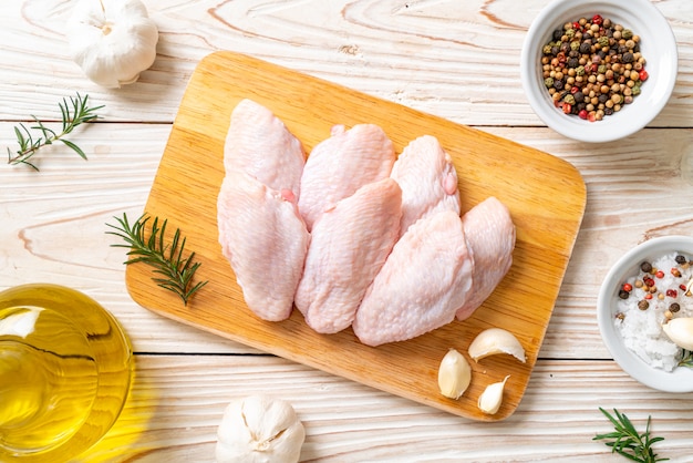 fresh raw middle chicken wings on wooden board