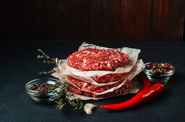 Fresh raw minced meat on baking sheets