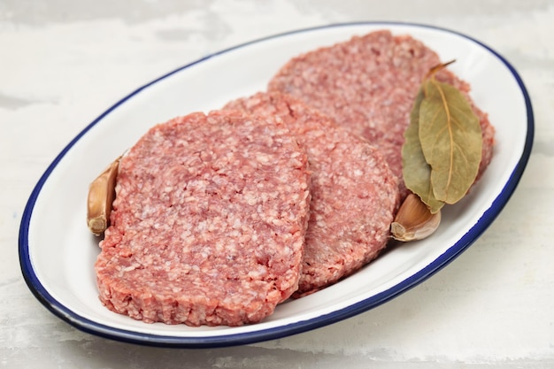 Fresh raw minced meat on white dish on dish