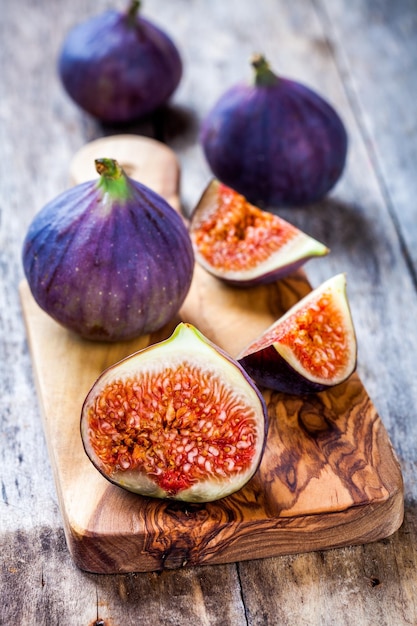 Fresh raw organic figs on a wooden background