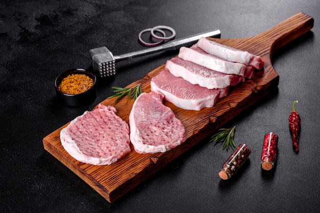 A fresh raw piece of pork escalop cut into several parts