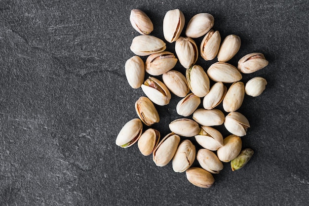 Fresh raw Pistachios isolated on dark background High ewsolution image