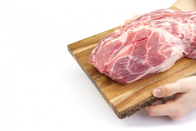 Fresh raw pork neck on wooden cutting board