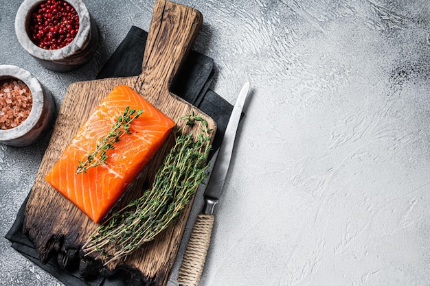 Fresh Raw salmon fillet steak on wooden board White background Top view Copy space