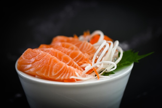 Fresh raw salmon fish for cooking food seafood salmon fish salmon sashimi food salmon fillet japanese menu with shiso perilla leaf lemon herb and spices