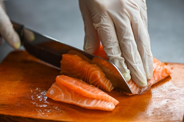 Fresh raw salmon fish fillet with kitchen knife for cooking food seafood salmon fish salmon fillet on wooden cutting board