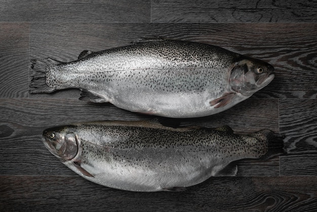 Fresh raw salmon red fish on a wooden table Creative layout made of fish seafood top view flat lay