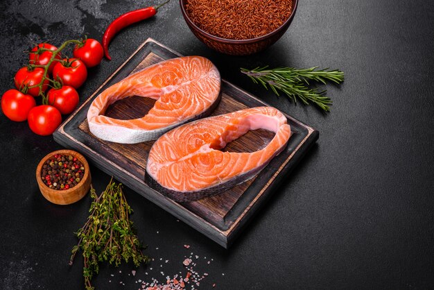 Fresh raw salmon steak with spices and herbs