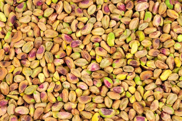 Fresh raw shelled pistachio nut kernel background