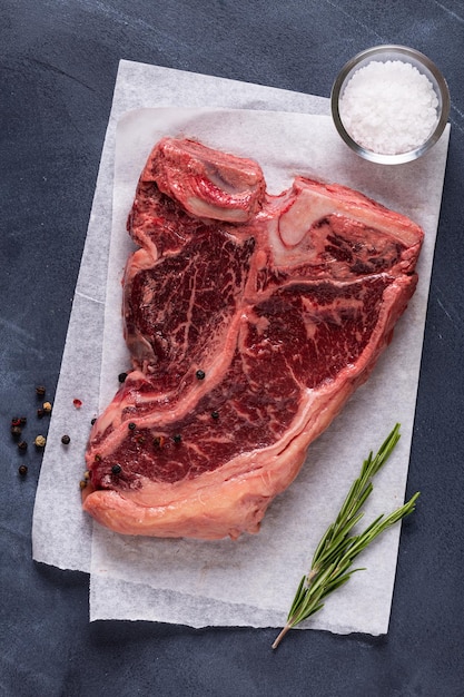 Fresh raw tbone steak on dark background