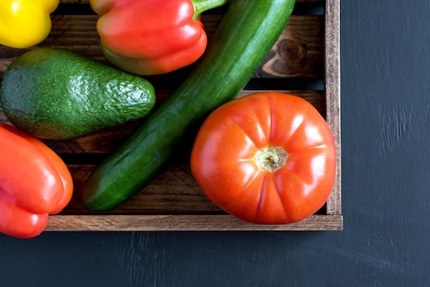 Fresh raw vegetable ingredients for healthy cooking or salad making with rustic wooden tray