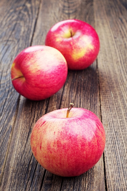 Fresh red apples on a wooden table