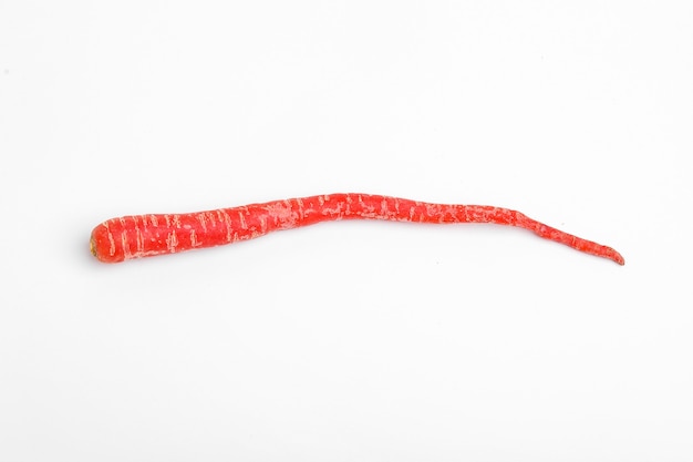 Fresh red carrot bunch on white surface