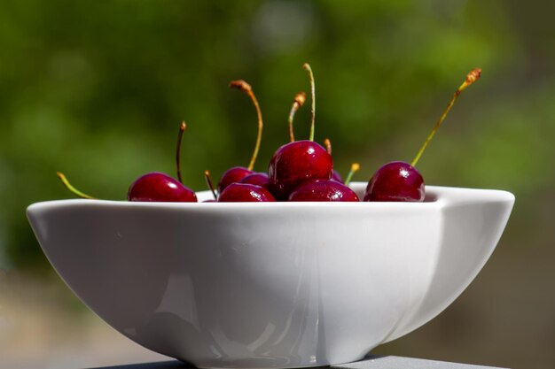 Fresh Red Cherries in a White Bowl