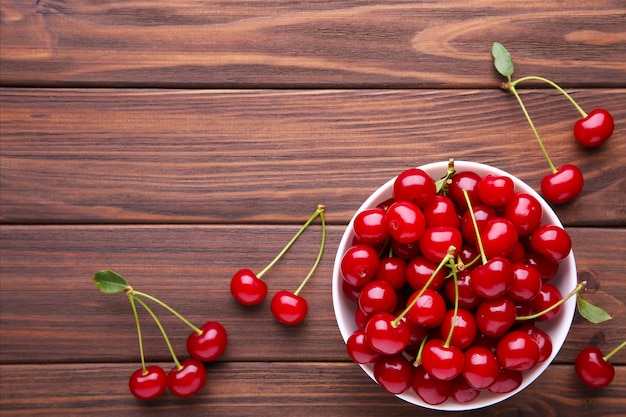 Fresh red cherry fruit on brown wooden table