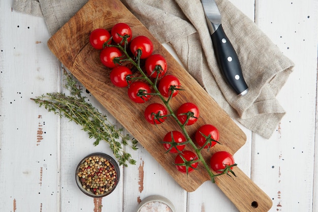 Fresh red cherry tomatoes on white wooden background