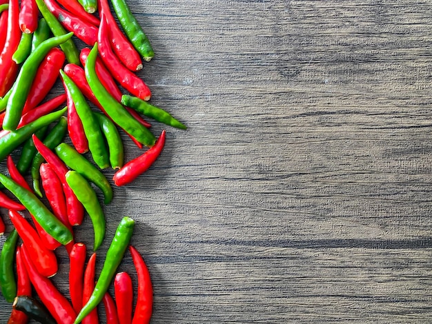 Fresh red chili and space for text on wooden background