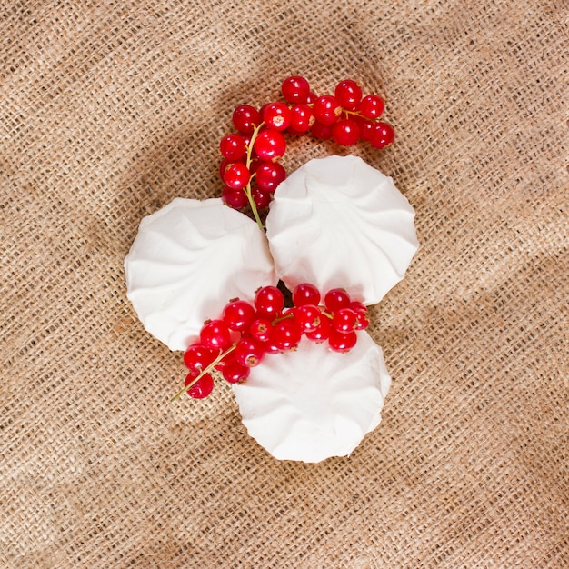 Fresh red currants and a white marshmallows