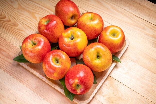 Fresh red Envy apple on wooden background Envy apple on wooden plate