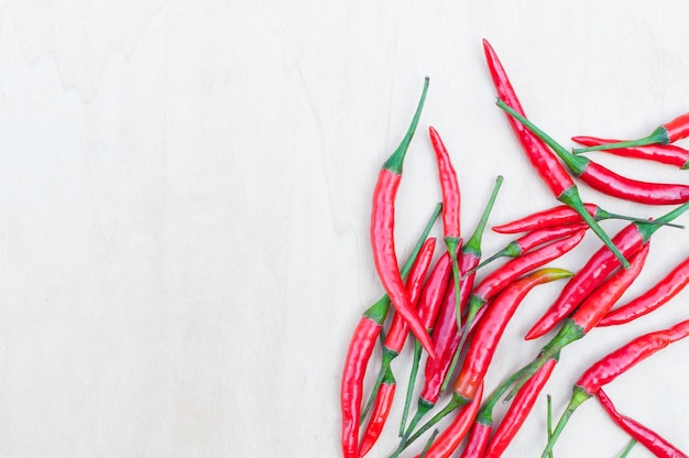 Fresh red hot chilli peppers with spicy on the wooden table with copy space