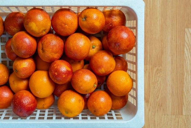 fresh red oranges in plastic crate top view b