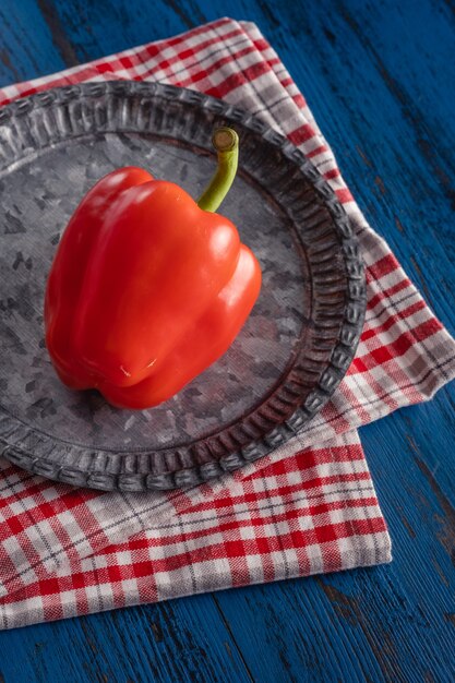 Fresh red paprika in rustic style on a blue wooden background