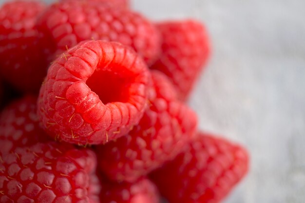 Fresh red raspberries on the table, close up.