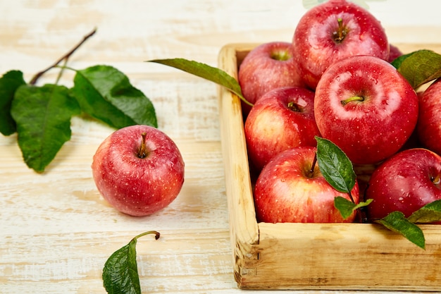 Fresh red ripe apples fruits in the wooden box