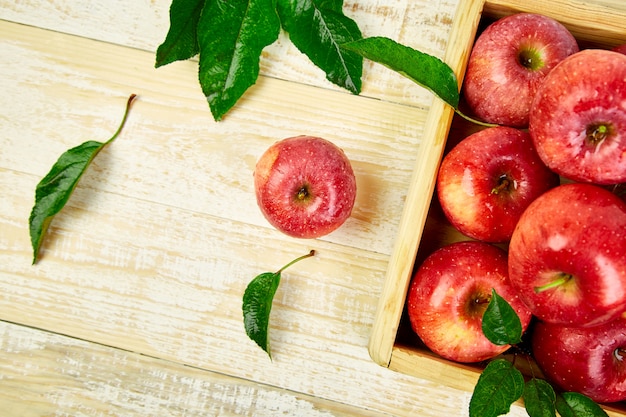 Fresh red ripe apples fruits in the wooden box