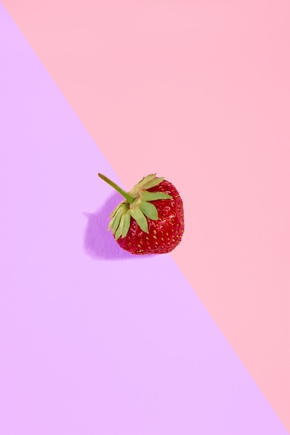 Fresh red strawberry isolated on pinkpurple background