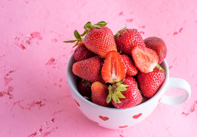 Fresh red strawberry in a white ceramic mug