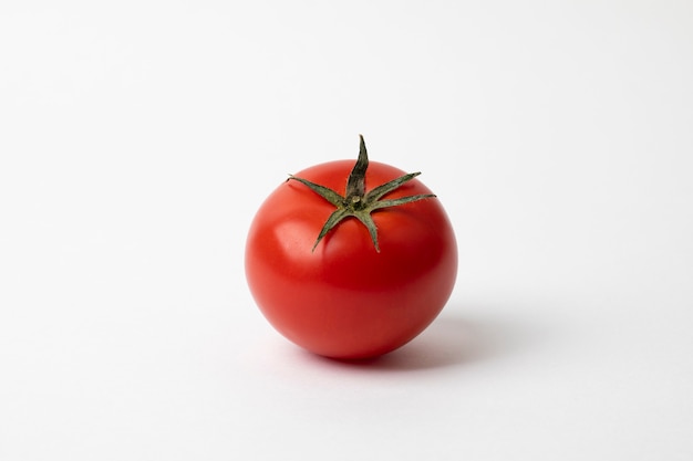 Fresh red tomato isolated on white surface