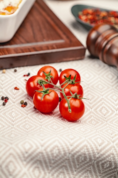 Fresh red tomatoes on background or light rustic table. Tomato variety 