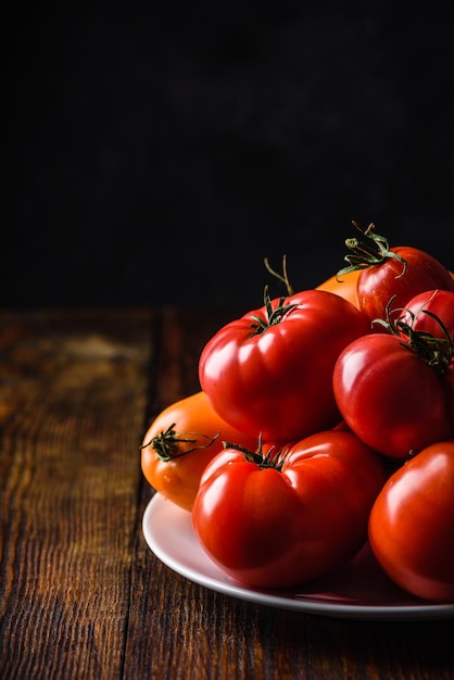 Fresh red and yellow tomatoes on plate