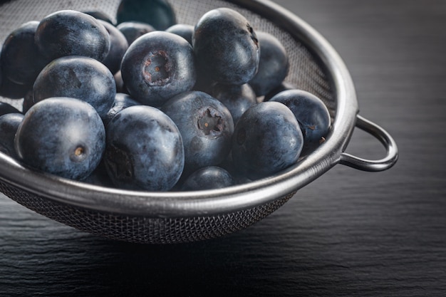 Fresh ripe blueberries in metal bowl