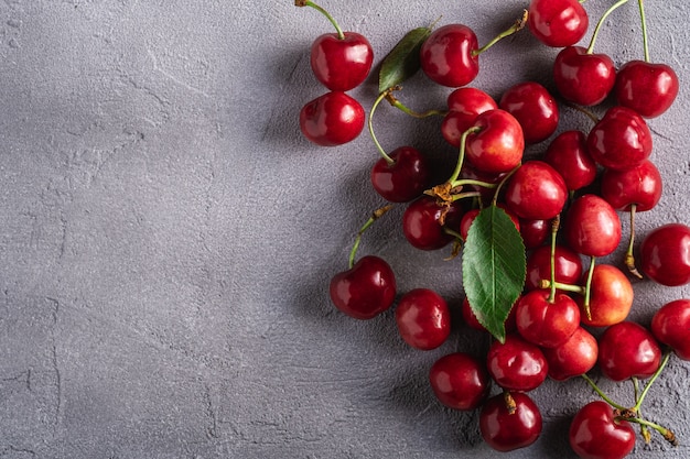 Fresh ripe cherry fruits with green leaves