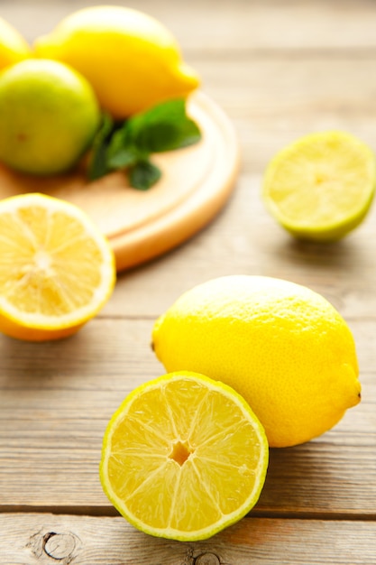 Fresh ripe citruses with mint on grey wood table. Vertical