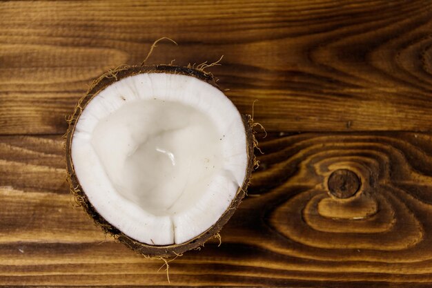 Fresh ripe coconut on rustic wooden table