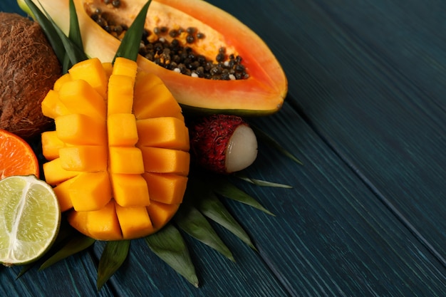 Fresh ripe exotic fruits on wooden background.