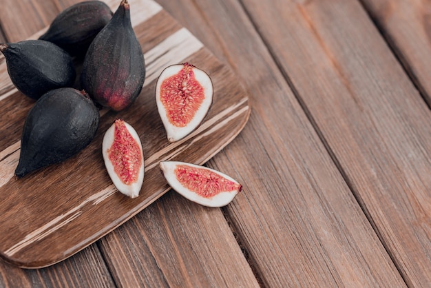 Fresh ripe figs on the brown wooden