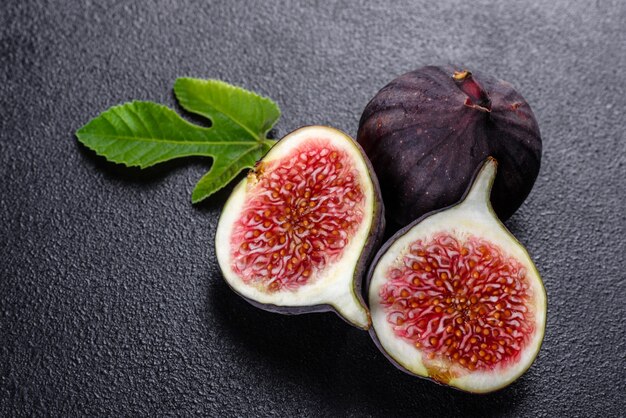 Fresh ripe figs on dark table