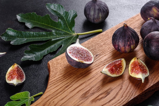 Fresh ripe figs on dark table