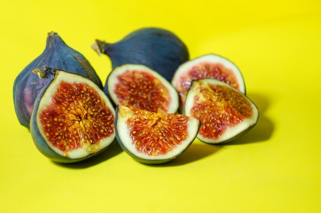 Fresh ripe figs on a yellow background Sweet sliced figs on the table View from above Copy space