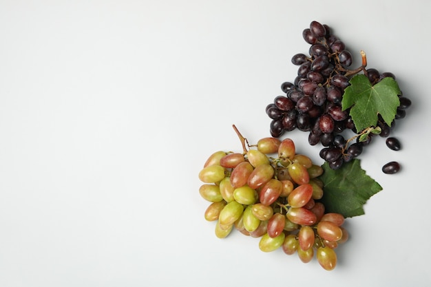 Fresh ripe grape with leaves on white