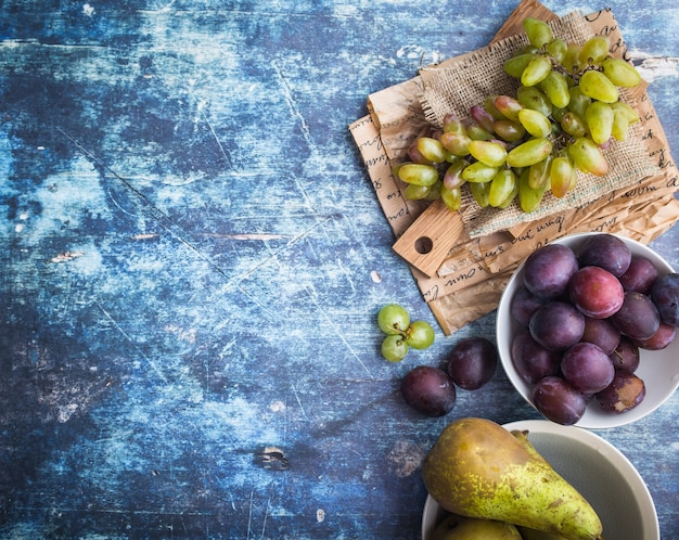 Fresh ripe grapes on wooden cutting board