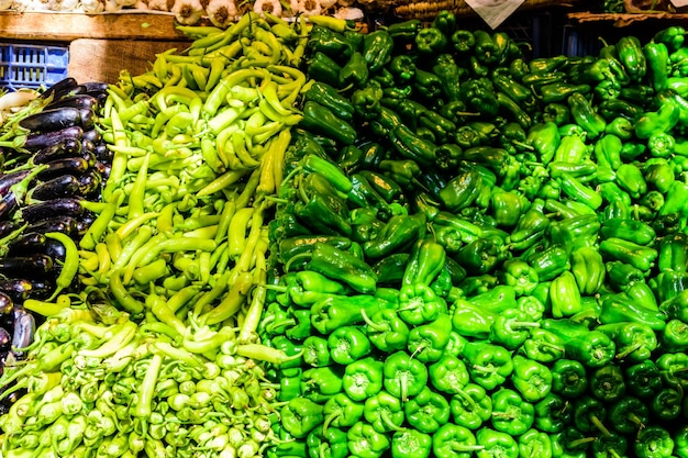 Fresh ripe green peppers for sale on a fruit market