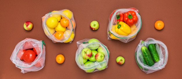 Fresh ripe and juicy fruits and vegetables in reusable eco friendly mesh bags.