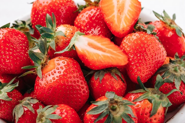 Fresh ripe juicy strawberries in a bowl closeup